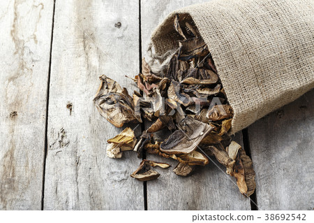 dried mushrooms scattered on the table dried mushrooms scattered on the table 38692542