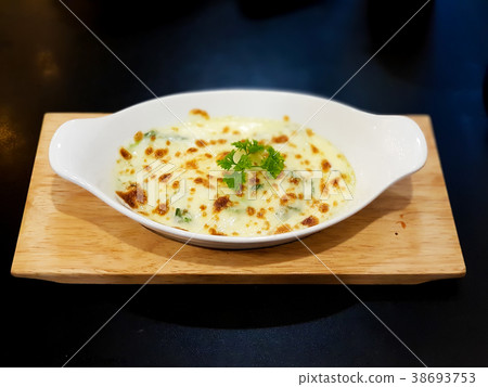 Baked spinach with cheese on white plate 38693753