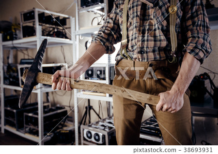 Strong hands of a man holding a pick 38693931