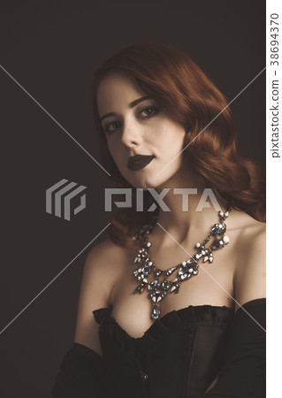 Young redhead woman in black corset Young redhead woman in black corset 38694370