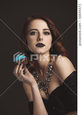 mystery girl in black clothes with blue cupcake mystery girl in black clothes with blue cupcake 38694371
