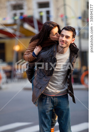Young couple hugging on the street Young couple hugging on the street 38694377