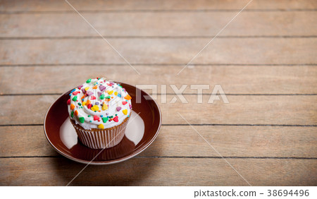 Colorful cupcake on a plate Colorful cupcake on a plate 38694496