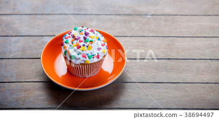 Colorful cupcake on a plate Colorful cupcake on a plate 38694497