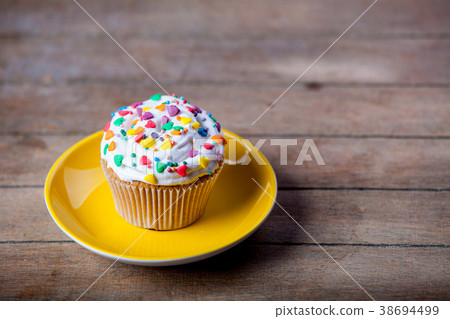Colorful cupcake on a plate Colorful cupcake on a plate 38694499