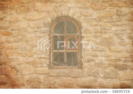 Old medieval window with lattice in brick wall Old medieval window with lattice in brick wall 38695559