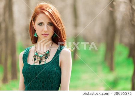 redhead girl in green dress in the park redhead girl in green dress in the park 38695575