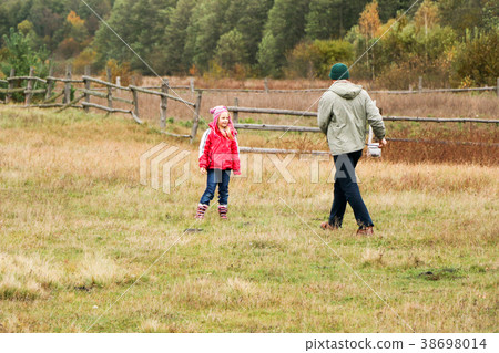 Young father playing with his daughter in a field 38698014