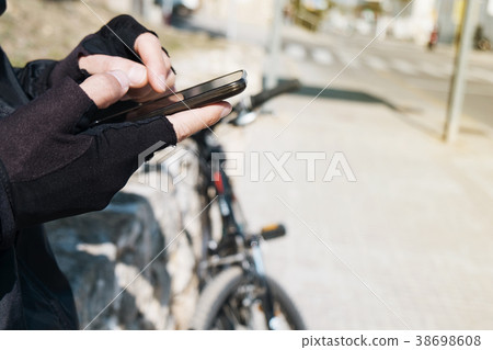 young cyclist man using a smartphone 38698608