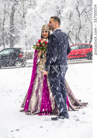 Happy couple in traditional turkish wedding dress 38700054