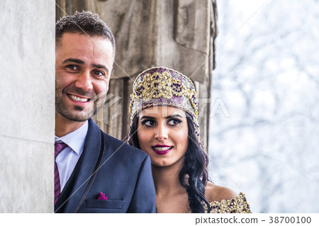 Happy couple in traditional turkish wedding dress Happy couple in traditional turkish wedding dress 38700100