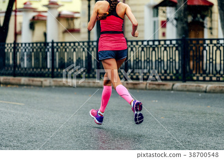 female runner in pink compression calf sleeves female runner in pink compression calf sleeves 38700548