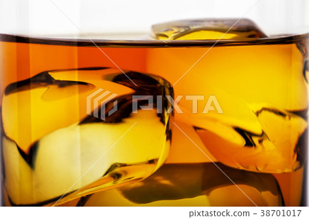 Fragment of glass of whiskey with ice 38701017
