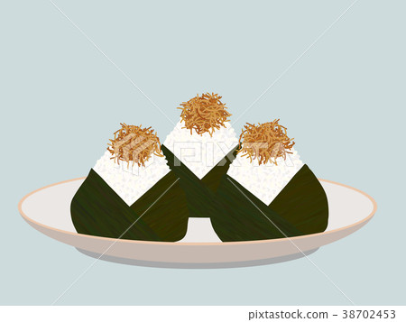 Onigiri topped with small fish fry on the plate. 38702453