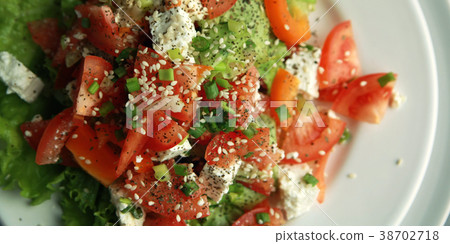 Tomato salad on the white plate. Top view Close up Tomato salad on the white plate. Top view Close up 38702718