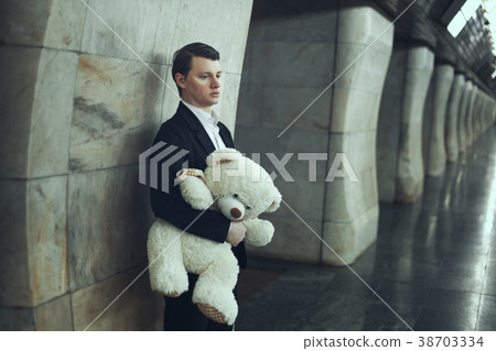 Sad Man with a bear toy. 38703334
