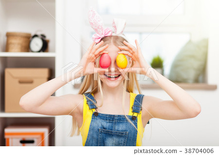 Teenage girl holding Easter eggs Teenage girl holding Easter eggs 38704006