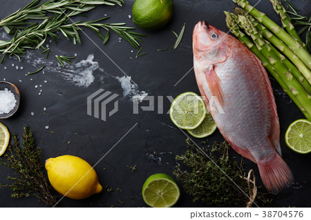 Raw red tilapia fish cooking 38704576