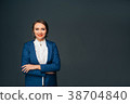Portrait confident business woman on gray 38704840