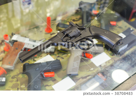 pistol on the glass table in army shop pistol on the glass table in army shop 38708483
