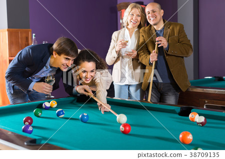 Group of adults playing pool. 38709135