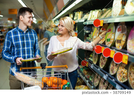 Happy family couple choosing chilled pizza Happy family couple choosing chilled pizza 38709149