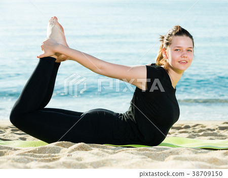 Female 20-30 years old is practicing asana in black T-shirt Female 20-30 years old is practicing asana in black T-shirt 38709150