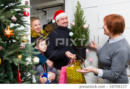 Senior woman meeting family of her son with Christmas gifts Senior woman meeting family of her son with Christmas gifts 38709157