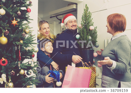 Man with family visiting mother for celebration of New Year Man with family visiting mother for celebration of New Year 38709159