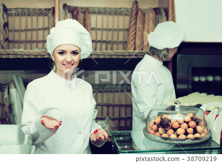 female cooks with fresh and tasty bread in bakery 38709219