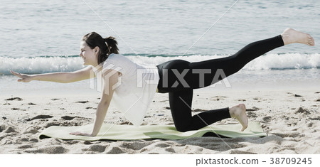 Girl in white T-shirt is practicing yoga 38709245