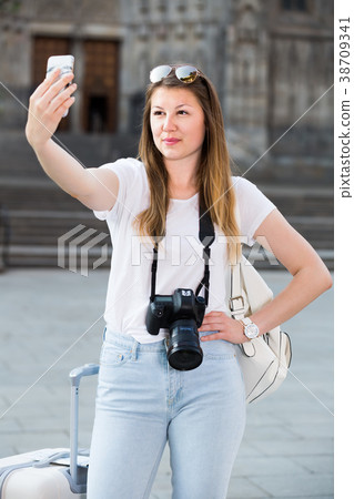 Energetic female tourist making selfie Energetic female tourist making selfie 38709341