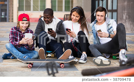 Teenage relaxing with mobile phones 38709478