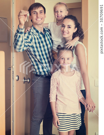 family standing at doorway 38709691