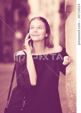 Cheerful girl talking on mobile phone 38710024