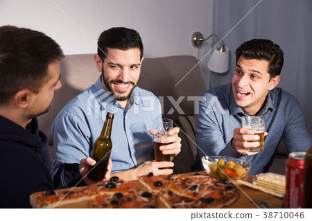 Three men talking and laughing at home Three men talking and laughing at home 38710046