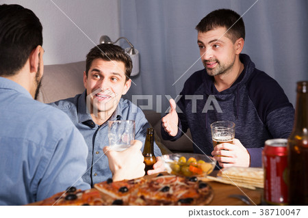 Three men talking and laughing at home Three men talking and laughing at home 38710047