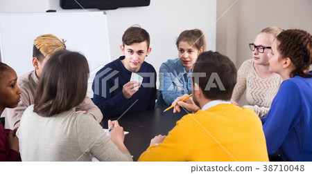 Classmates having round of guess-who game during class Classmates having round of guess-who game during class 38710048