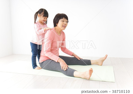 Senior woman and grandson doing gymnastics Senior woman and grandson doing gymnastics 38710110