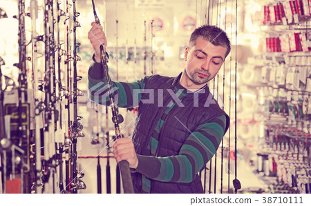 fisher selecting fishing rod fisher selecting fishing rod 38710111