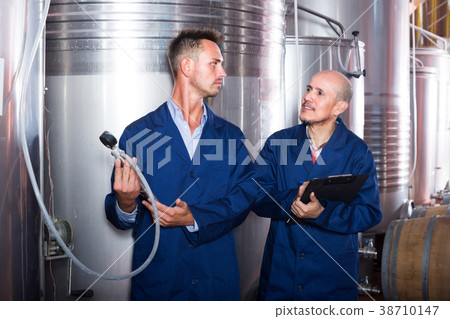 Two male employees at winery. 38710147