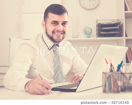 Male employee is having productive day at work Male employee is having productive day at work 38710148