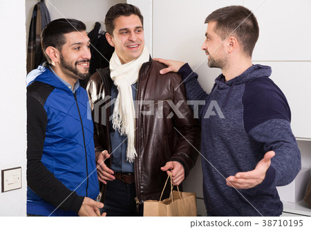 Three men getting for bachelor gatherings at home 38710195