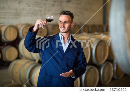 winery employee with wine sample in glass . 38710231