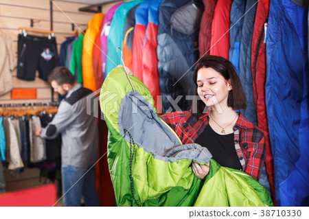 Woman shoosing new sleeping bag Woman shoosing new sleeping bag 38710330
