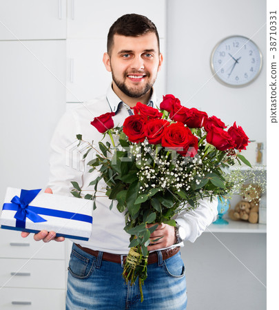 Man ready to present flowers and gift at holiday Man ready to present flowers and gift at holiday 38710331