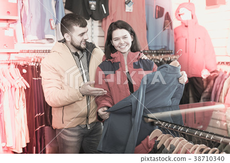Couple choosing jacket in store 38710340