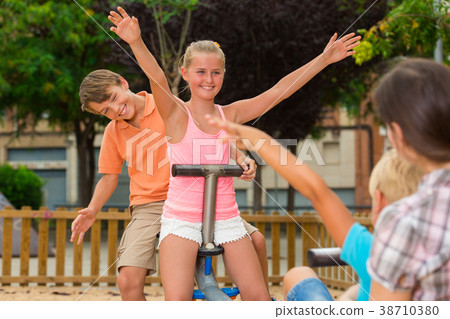 Children are teetering on the swing 38710380