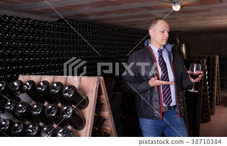Winemaker degusting red wine in wine cellar Winemaker degusting red wine in wine cellar 38710384