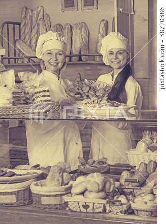 Friendly women at bakery display Friendly women at bakery display 38710386